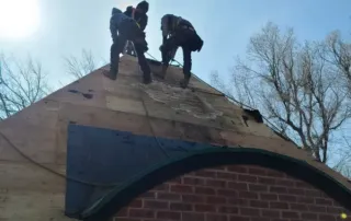Roofing contractors from A-Denver Roofing inspect and replace damaged decking on a residential roof, helping homeowners choose between roof repair or replacement.